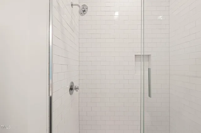 a bathroom with a double vanity sink toilet and mirror