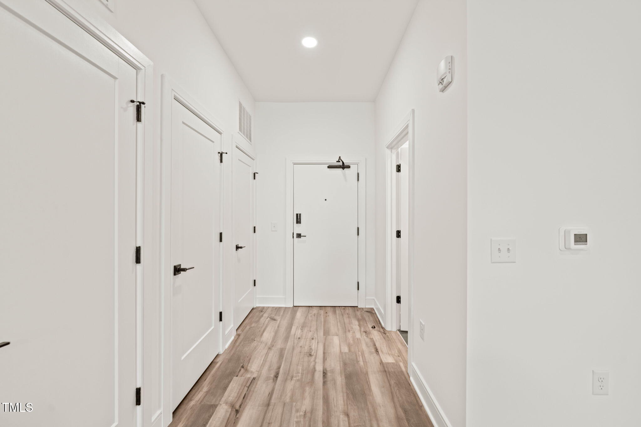 615 Daniels Street, Unit 215 Raleigh, NC 27605 - Photo 6 of 37 a view of a room with wooden floor and white doors