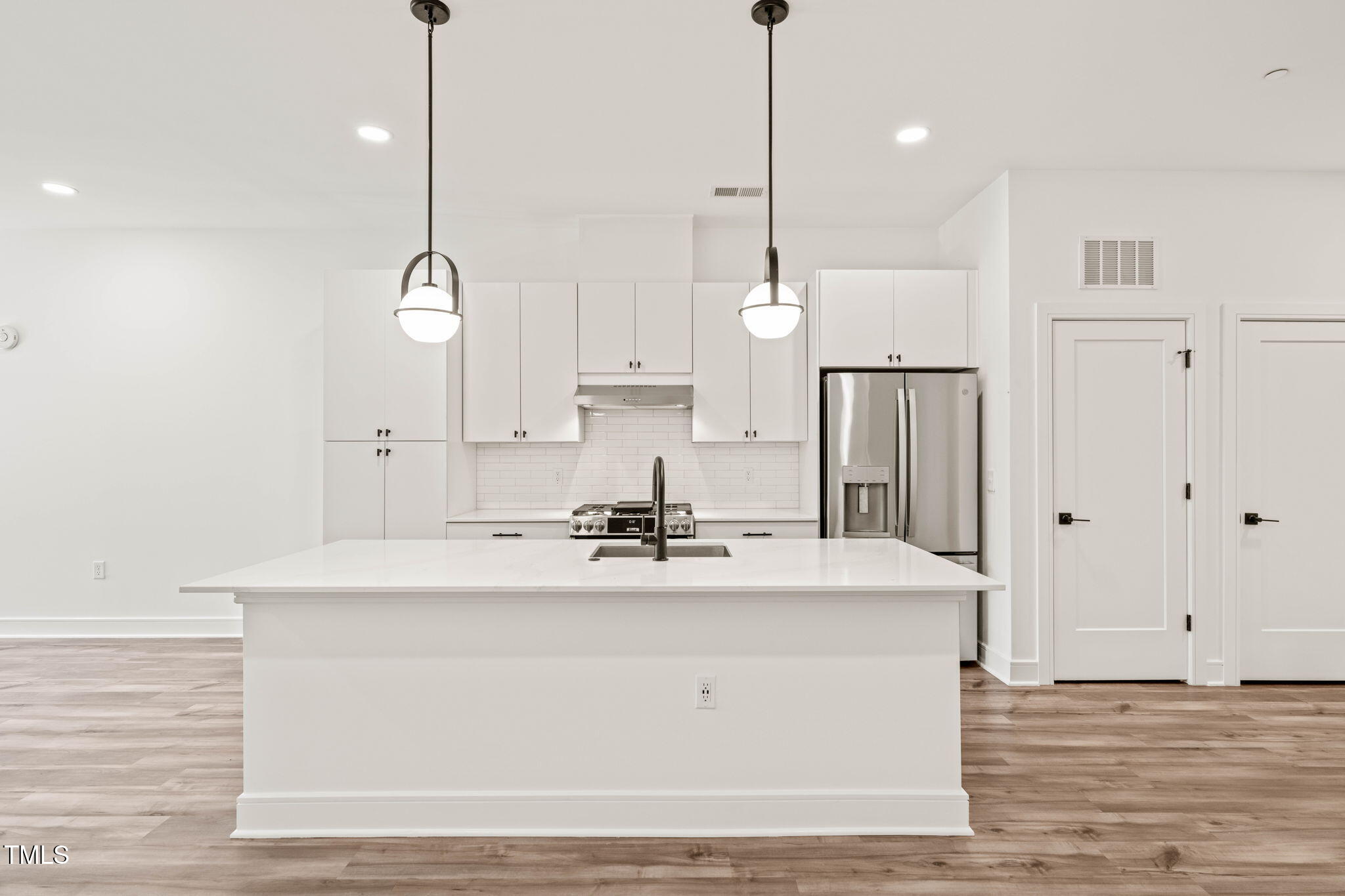 615 Daniels Street, Unit 215 Raleigh, NC 27605 - Photo 8 of 37 a view of kitchen with stainless steel appliances kitchen island sink stove and living room view