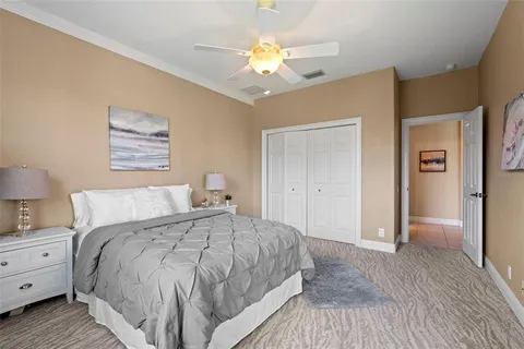 a spacious bedroom with a bed and a chandelier