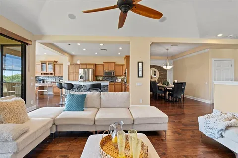 a living room with furniture and kitchen view