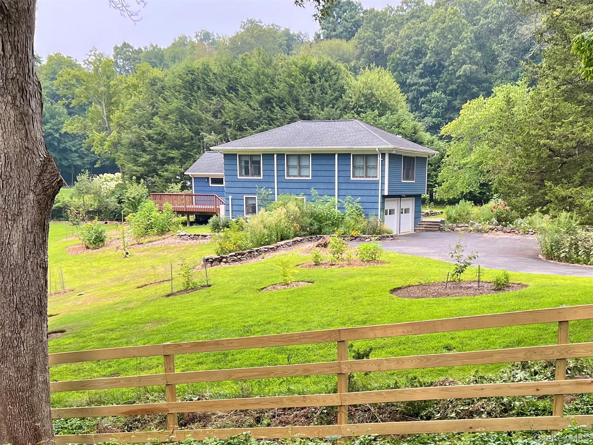 119 Mustato Road Katonah, NY 10536 - Photo 2 of 23 a front view of a house with garden