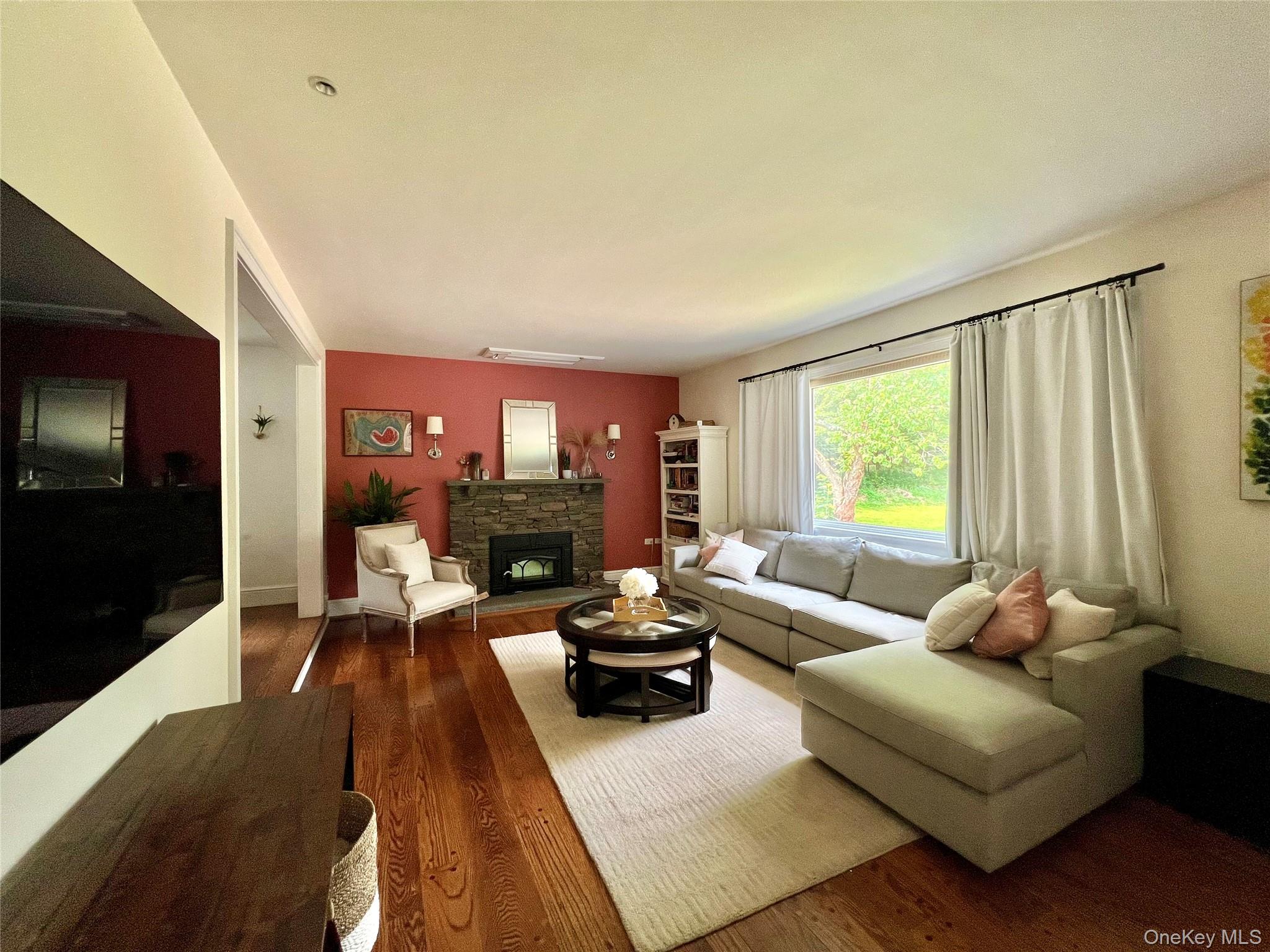 119 Mustato Road Katonah, NY 10536 - Photo 3 of 23 a living room with furniture a large window and a flat screen tv