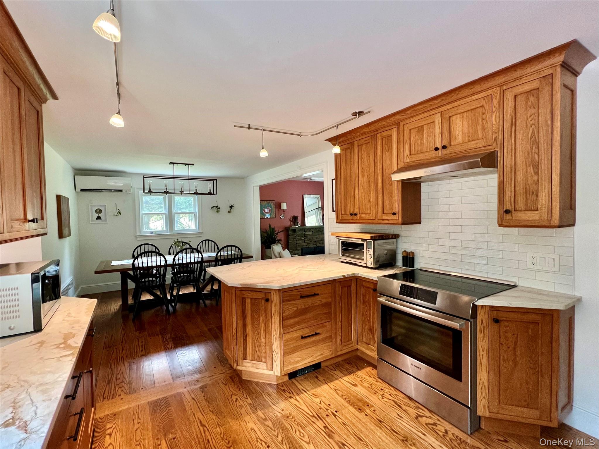 119 Mustato Road Katonah, NY 10536 - Photo 6 of 23 a kitchen that has a lot of cabinets a sink and wooden floor