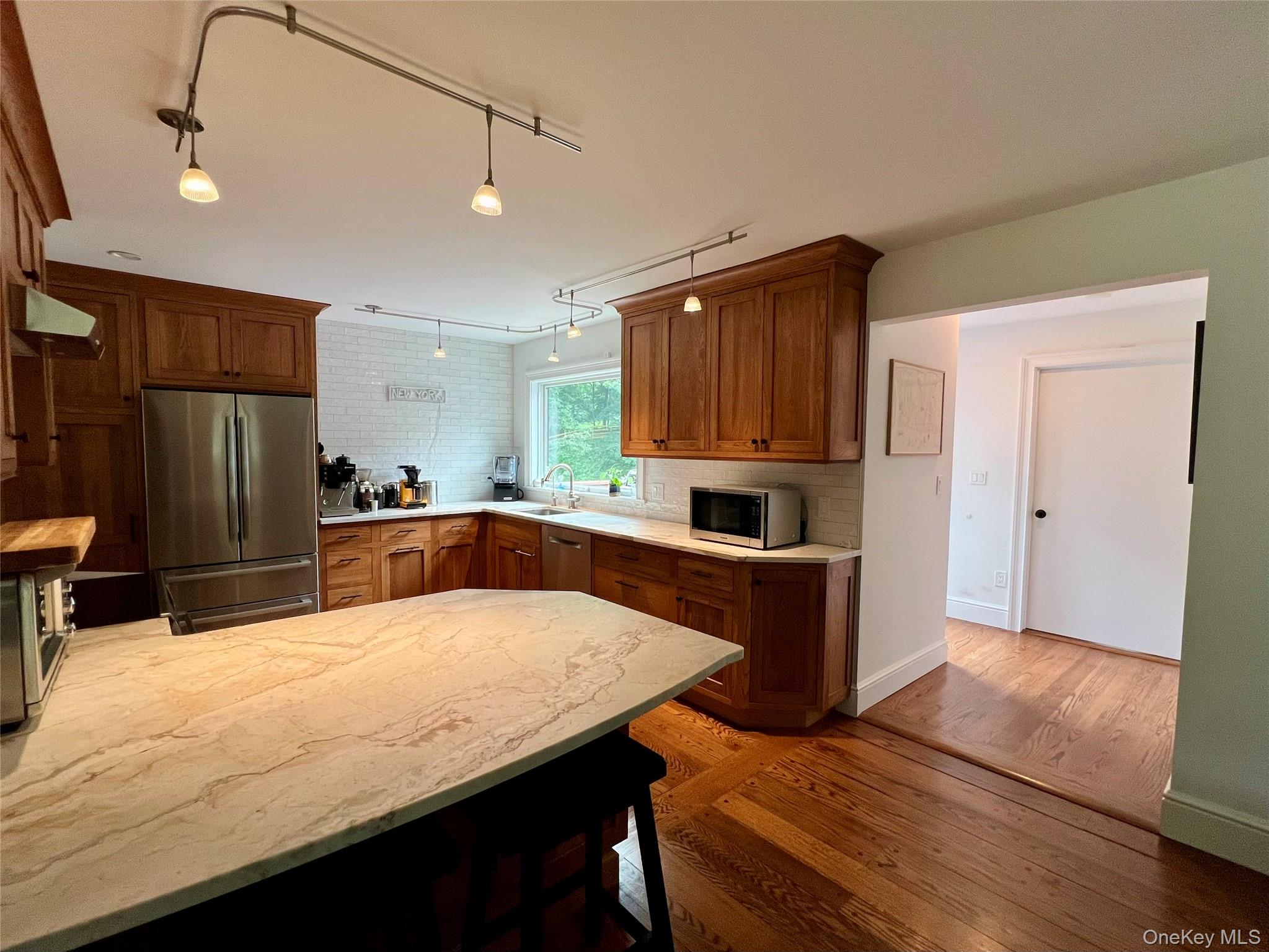 119 Mustato Road Katonah, NY 10536 - Photo 7 of 23 a kitchen with stainless steel appliances wooden cabinets a refrigerator and a sink