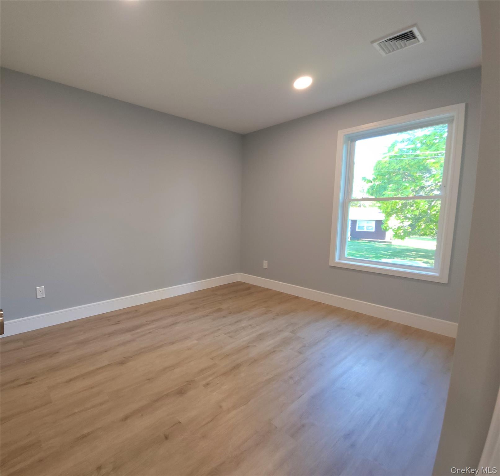 15 Greising Street Pine Bush, NY 12566 - Photo 18 of 22 a view of an empty room with wooden floor and a window