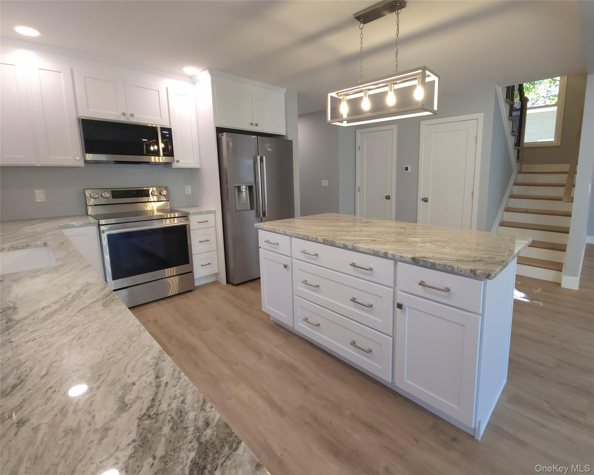 15 Greising Street Pine Bush, NY 12566 - Photo 3 of 22 a kitchen with stainless steel appliances granite countertop a stove a refrigerator and a sink