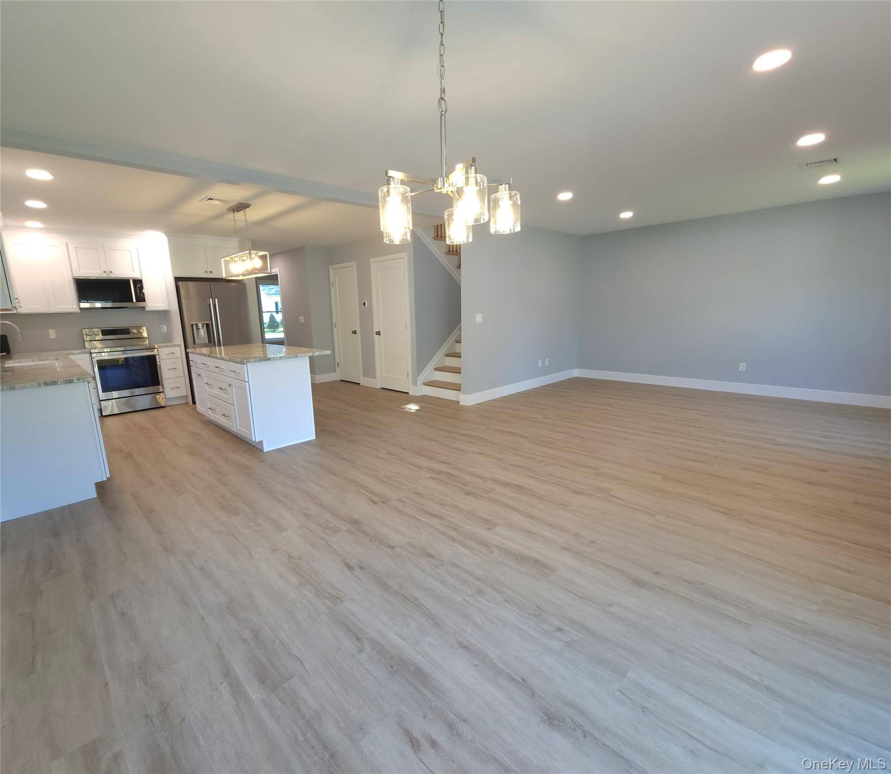 15 Greising Street Pine Bush, NY 12566 - Photo 6 of 22 a view of a room with kitchen island stainless steel appliances wooden floor and living room view