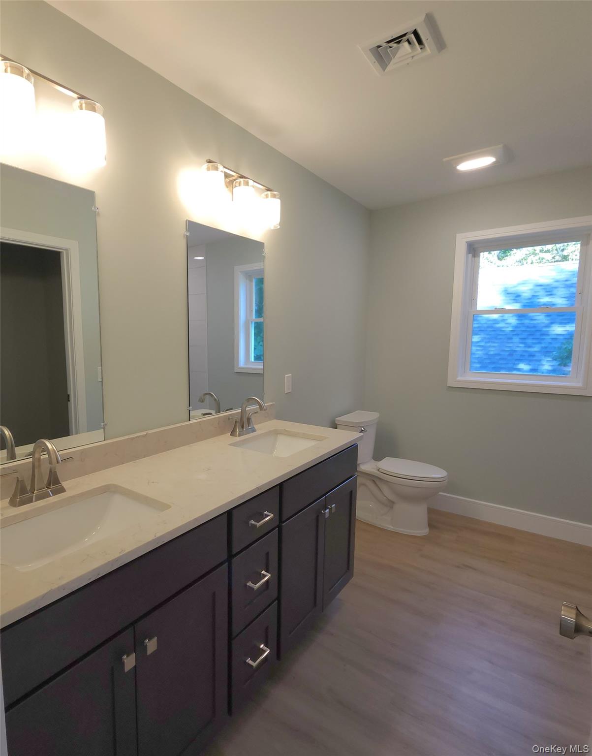15 Greising Street Pine Bush, NY 12566 - Photo 10 of 22 a bathroom with a double vanity sink toilet and a mirror