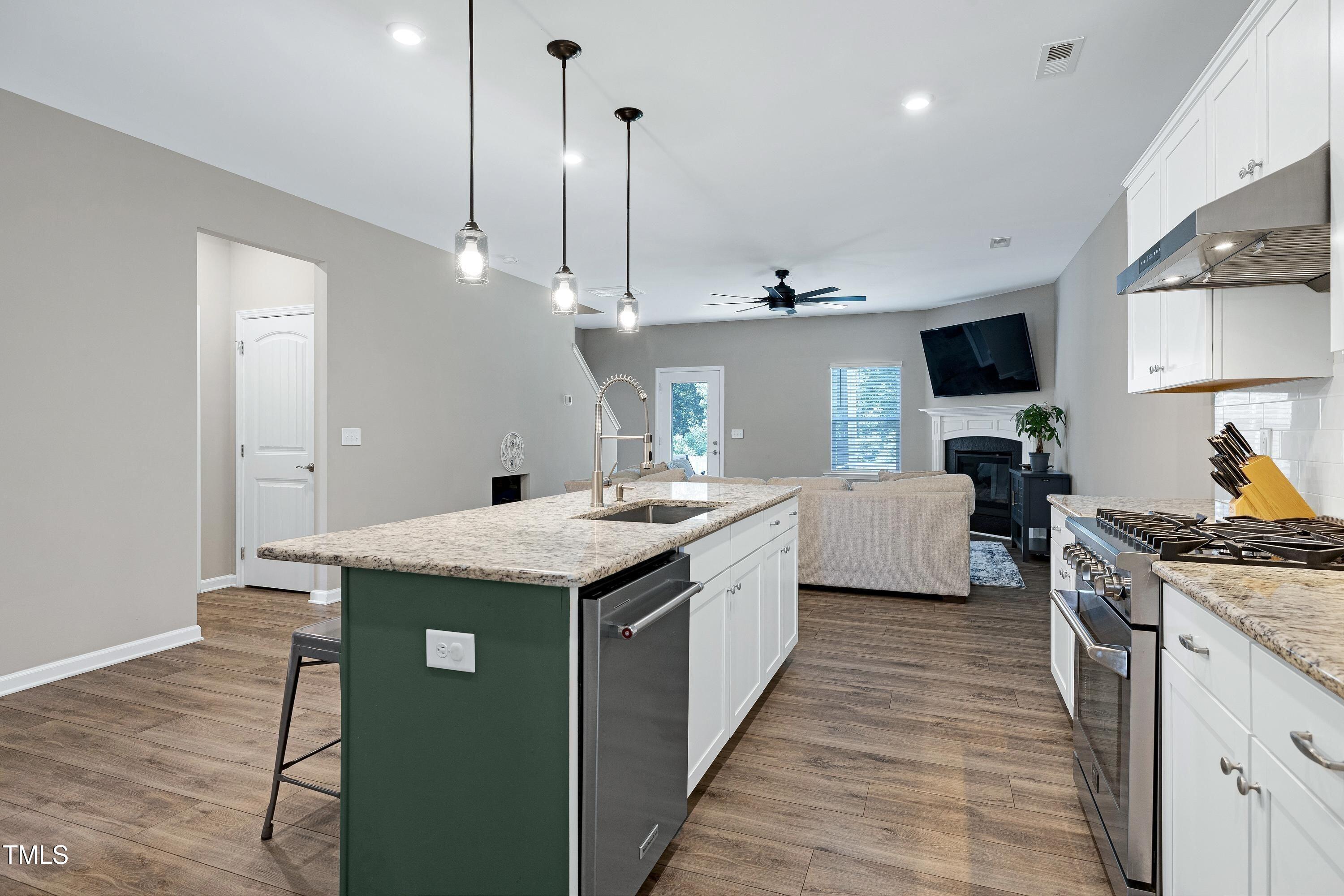 5300 Trilogy Farm Drive Raleigh, NC 27603 - Photo 11 of 50 a kitchen with a sink stove and wooden floor