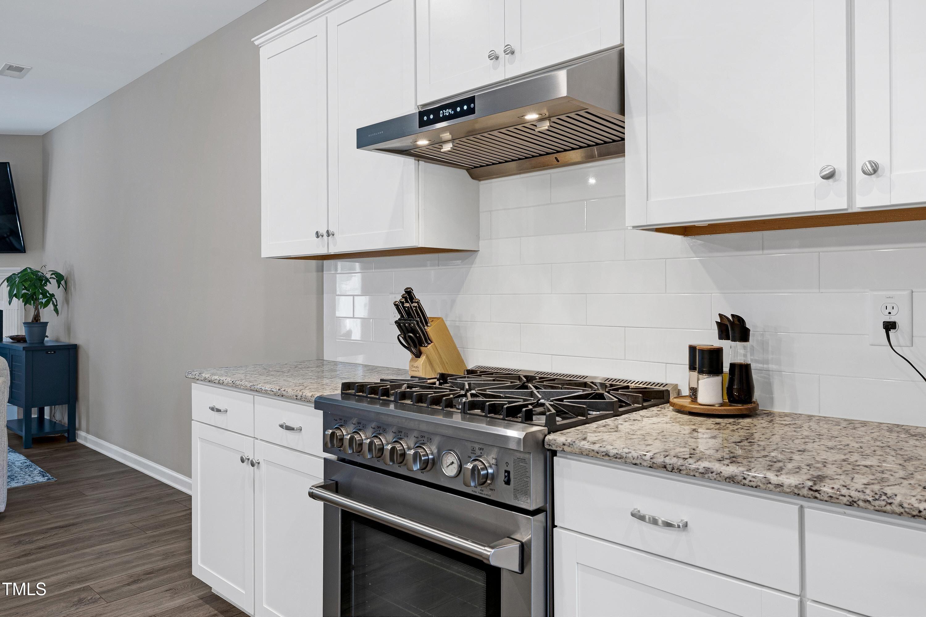 5300 Trilogy Farm Drive Raleigh, NC 27603 - Photo 12 of 50 a kitchen with granite countertop stainless steel appliances and cabinets
