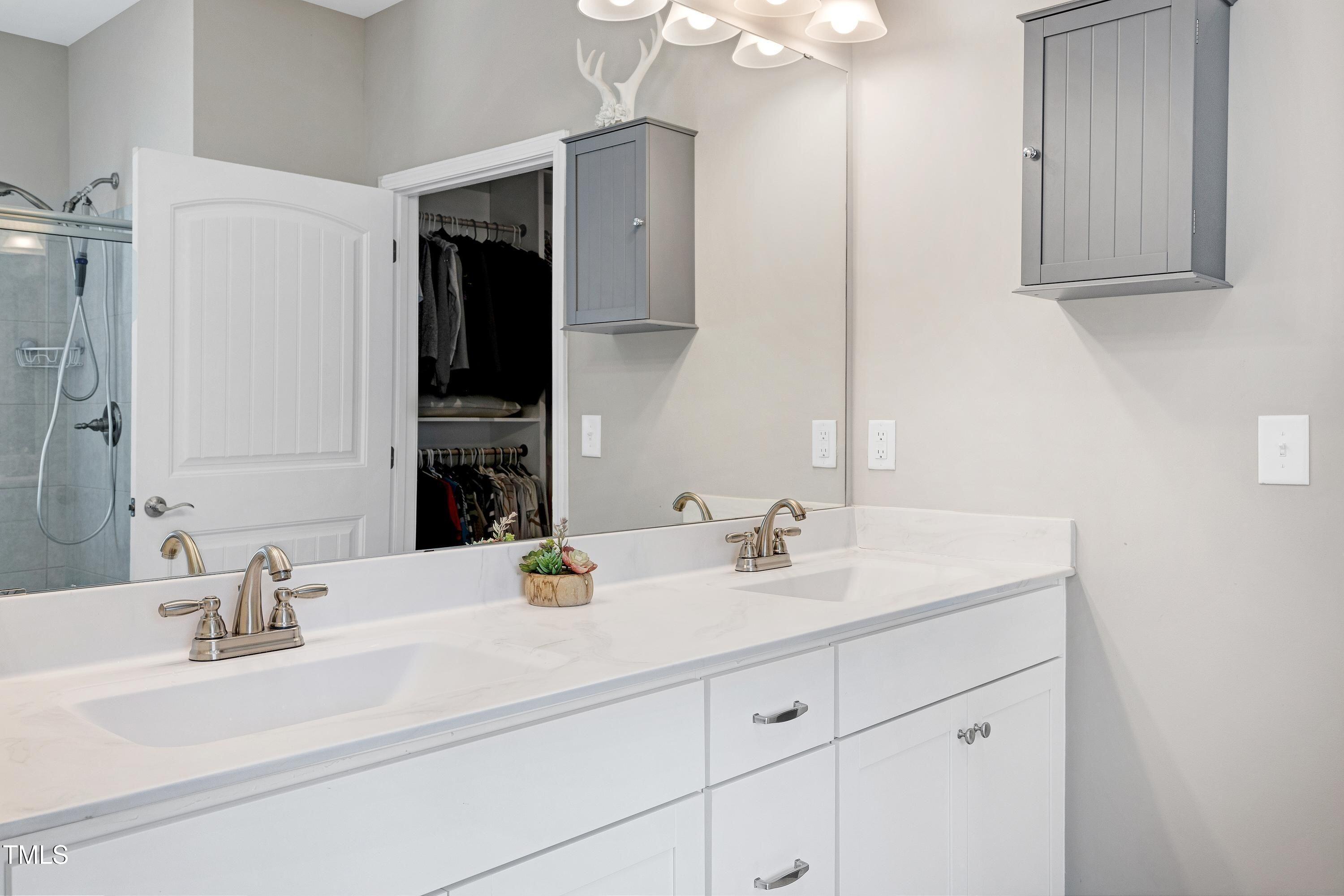5300 Trilogy Farm Drive Raleigh, NC 27603 - Photo 15 of 50 a bathroom with double vanity sink and a mirror