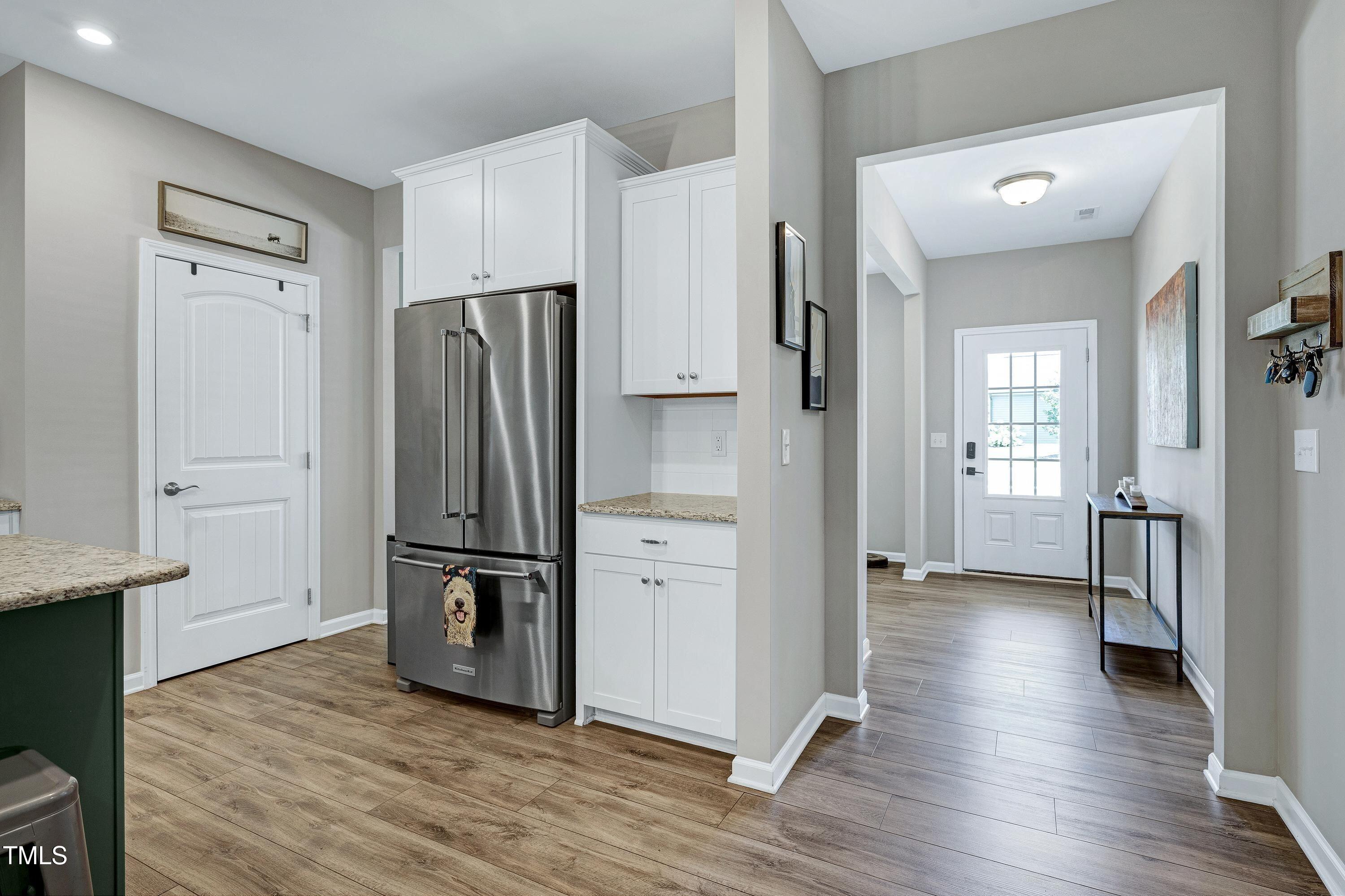 5300 Trilogy Farm Drive Raleigh, NC 27603 - Photo 16 of 50 a view of kitchen with refrigerator cabinet and wooden floor