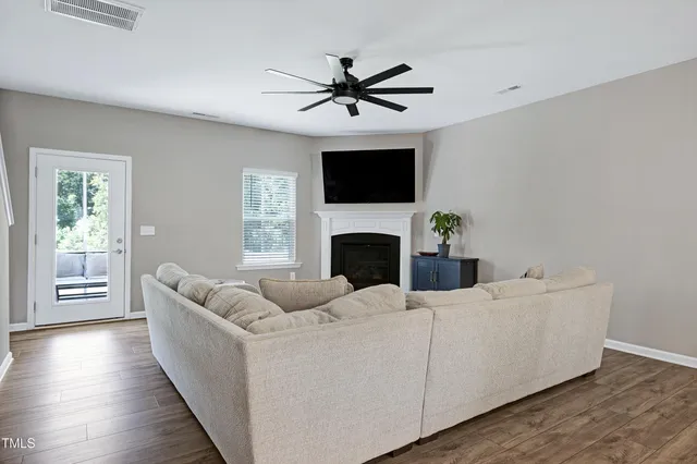 a living room with furniture a fireplace and a flat screen tv