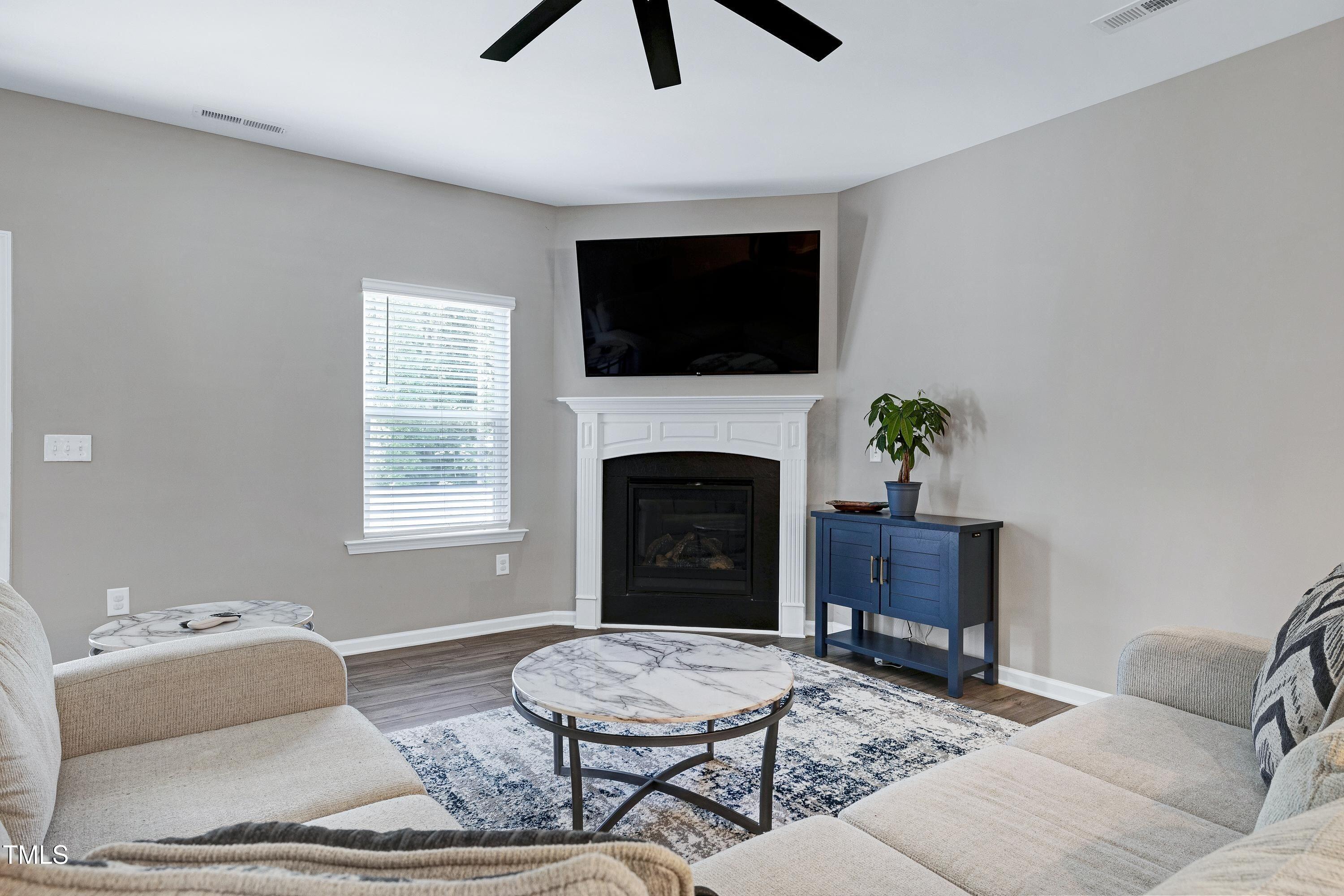 5300 Trilogy Farm Drive Raleigh, NC 27603 - Photo 18 of 50 a living room with furniture a flat screen tv and a fireplace