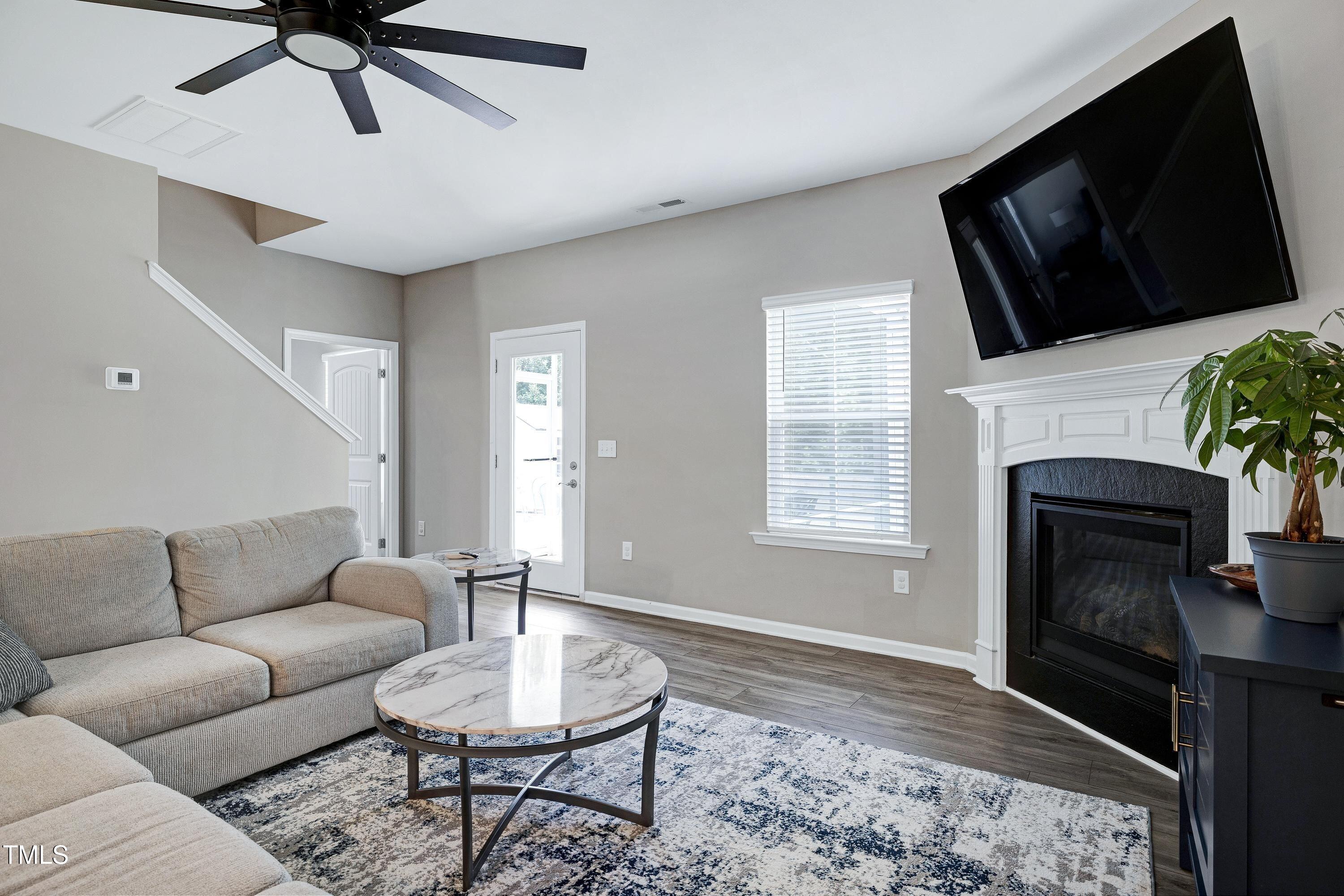5300 Trilogy Farm Drive Raleigh, NC 27603 - Photo 19 of 50 a living room with furniture a rug and a fireplace