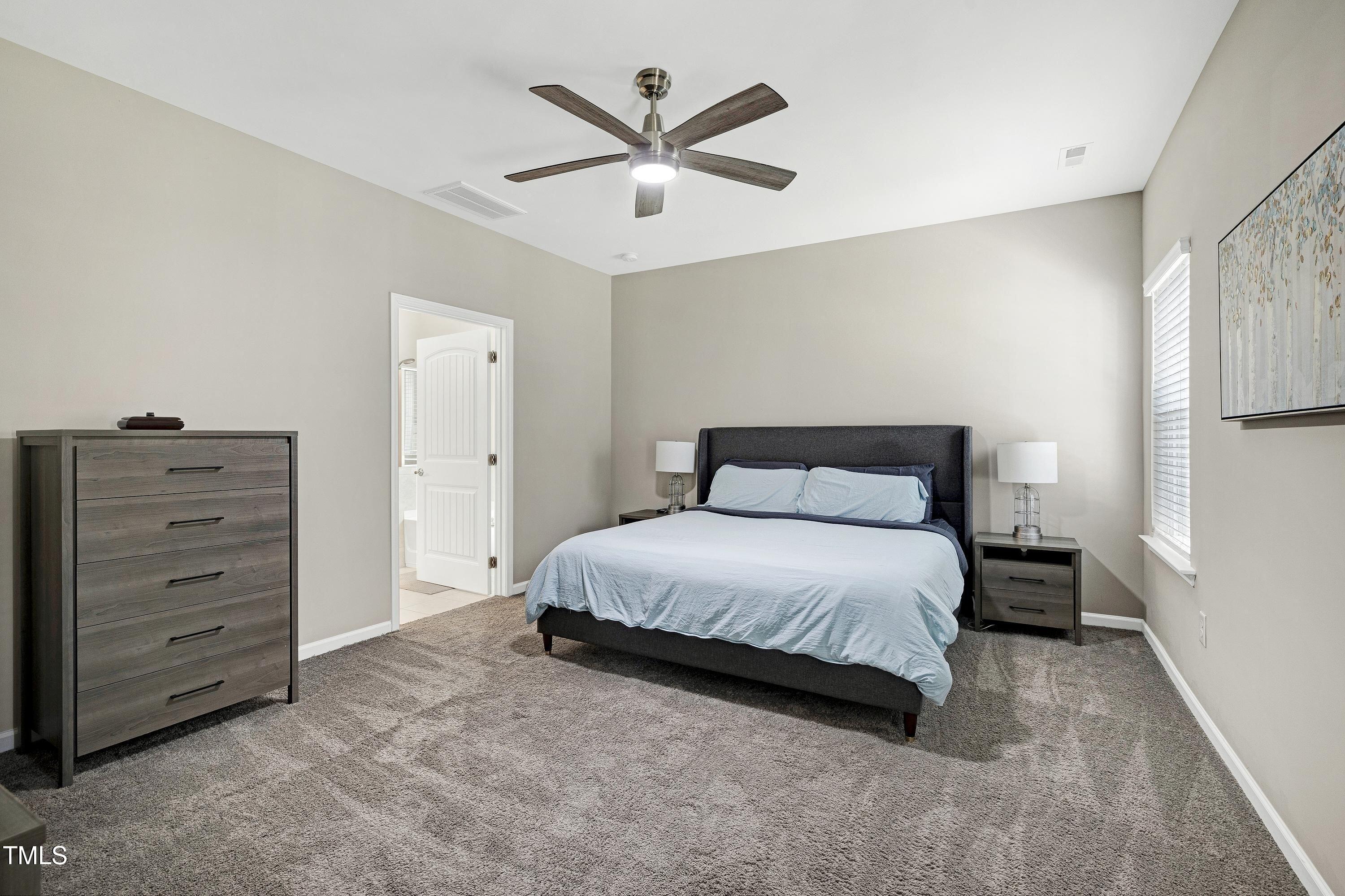 5300 Trilogy Farm Drive Raleigh, NC 27603 - Photo 23 of 50 a bedroom with a bed and a ceiling fan