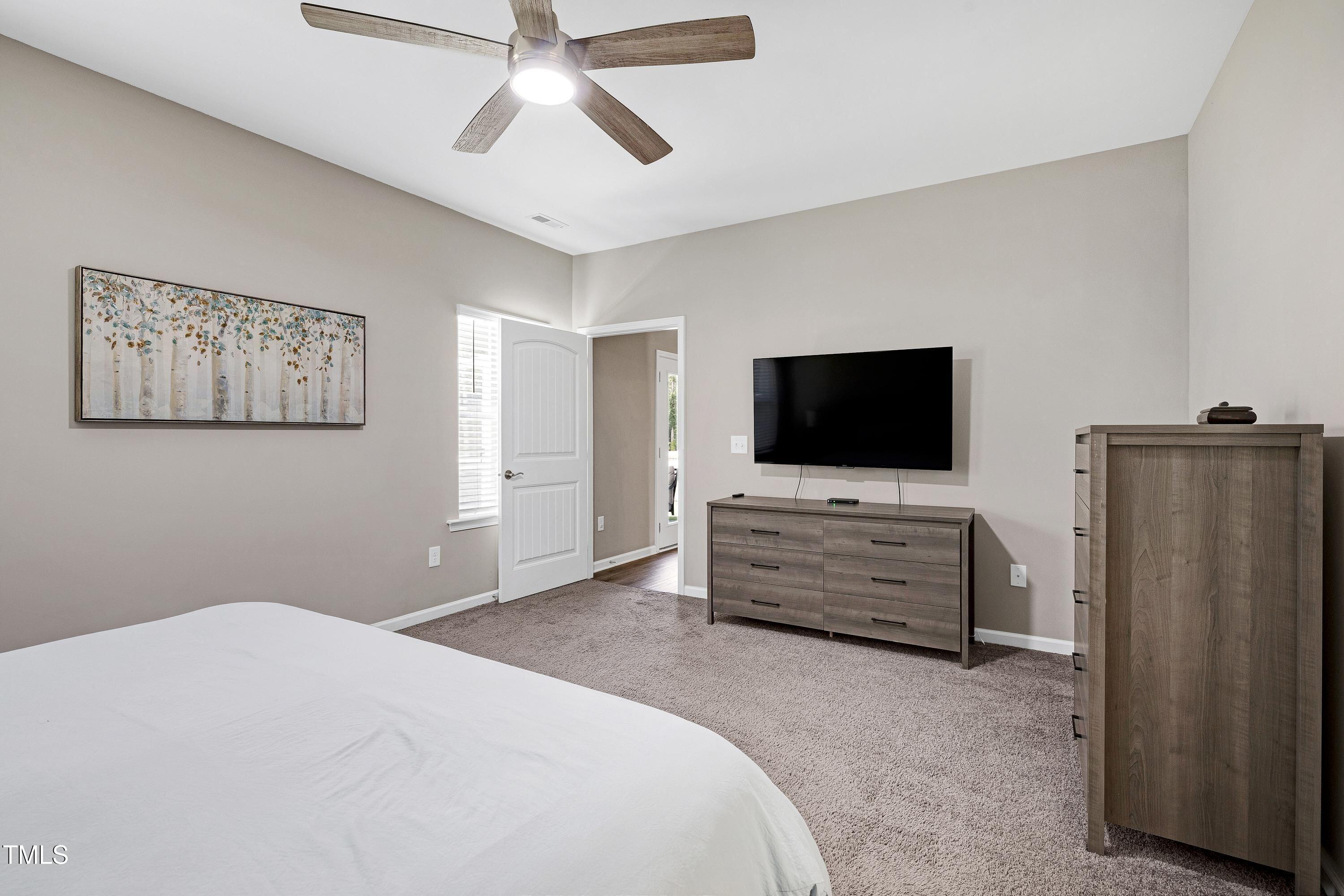 5300 Trilogy Farm Drive Raleigh, NC 27603 - Photo 24 of 50 a bedroom with furniture and flat screen tv