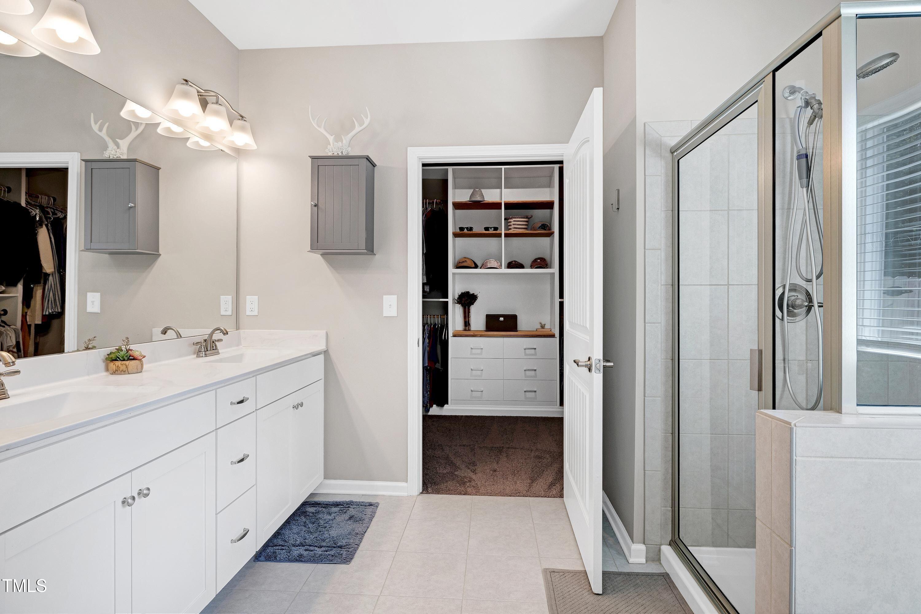 5300 Trilogy Farm Drive Raleigh, NC 27603 - Photo 27 of 50 a en suite bathroom with a double vanity sink a mirror and shower
