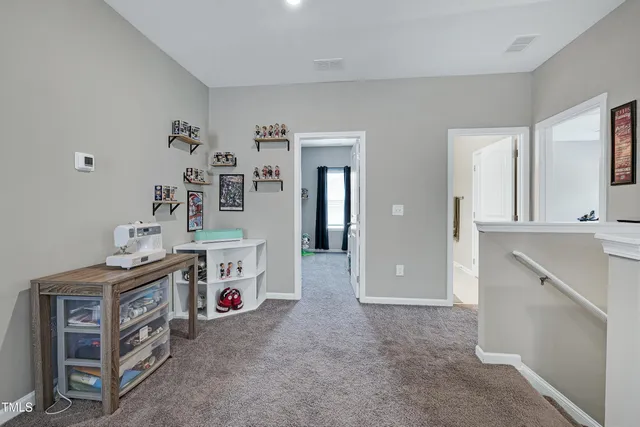 a living room with furniture and a wall painting