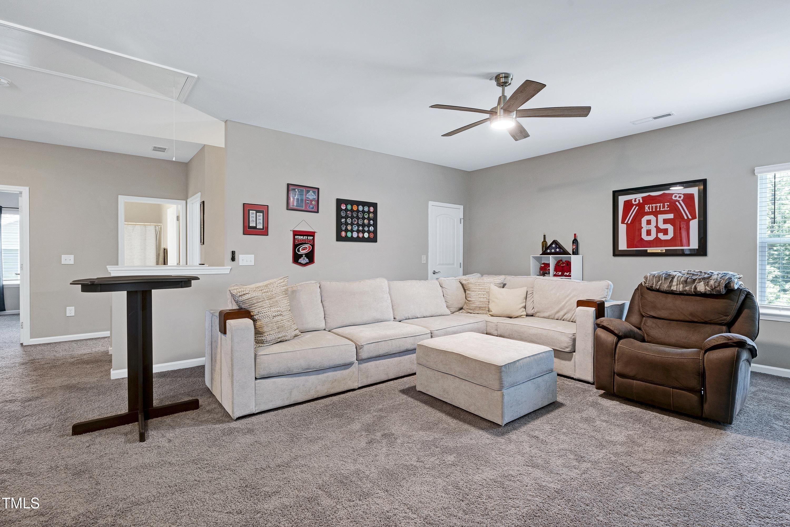 5300 Trilogy Farm Drive Raleigh, NC 27603 - Photo 31 of 50 a living room with furniture and a wall painting