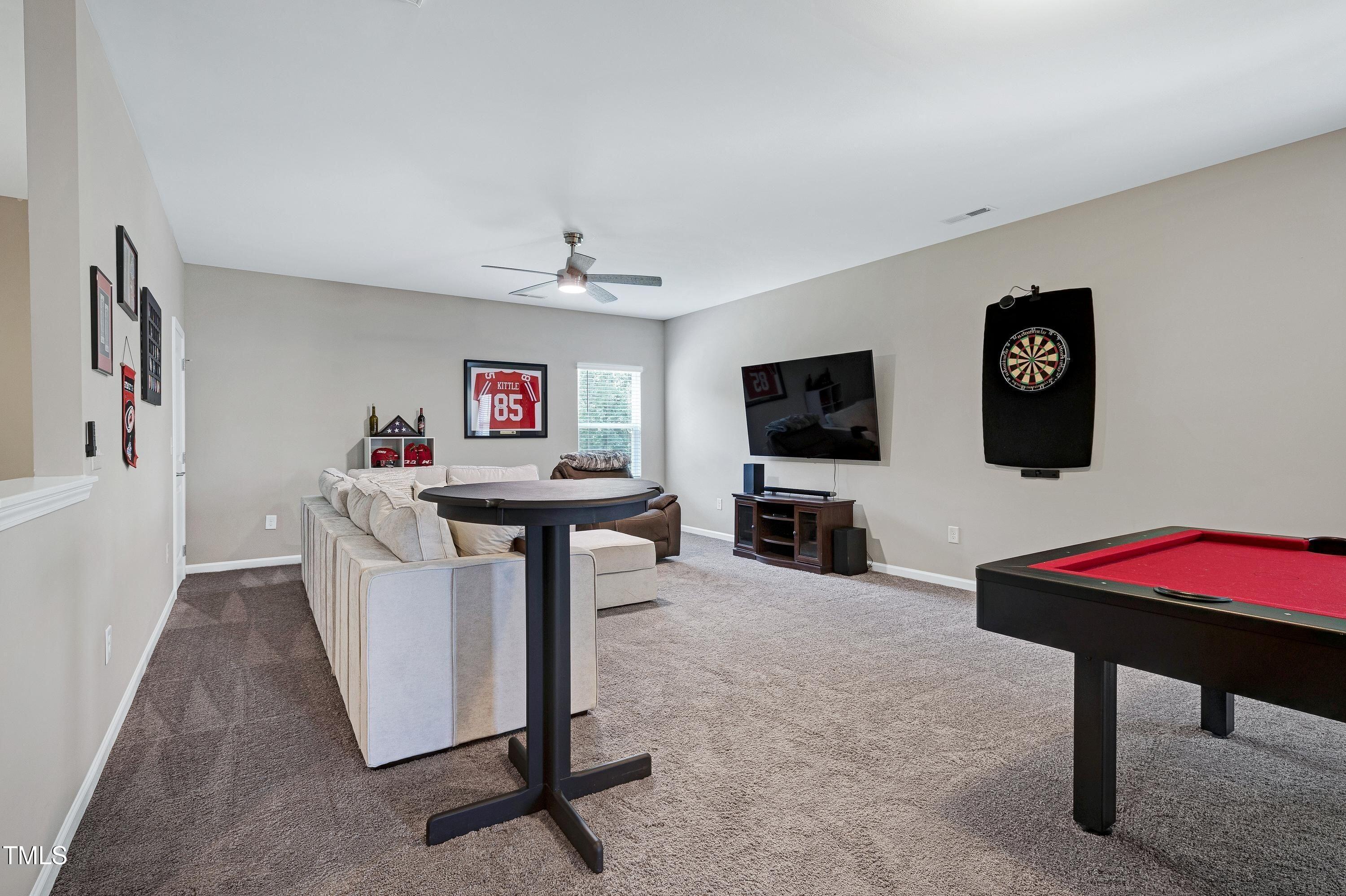 5300 Trilogy Farm Drive Raleigh, NC 27603 - Photo 32 of 50 a view of a livingroom with furniture and a flat screen tv