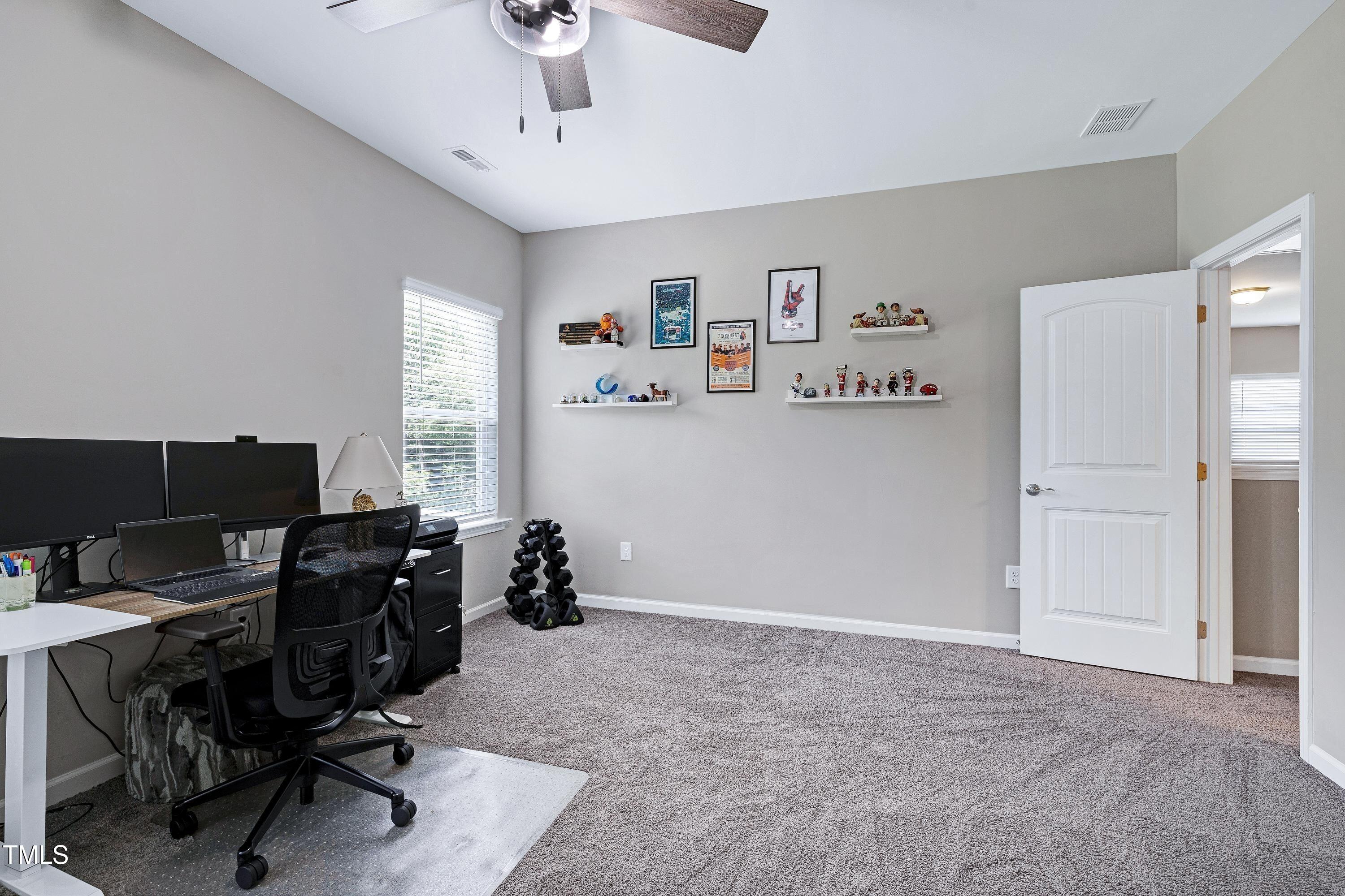 5300 Trilogy Farm Drive Raleigh, NC 27603 - Photo 35 of 50 a view of a workspace with furniture and a window