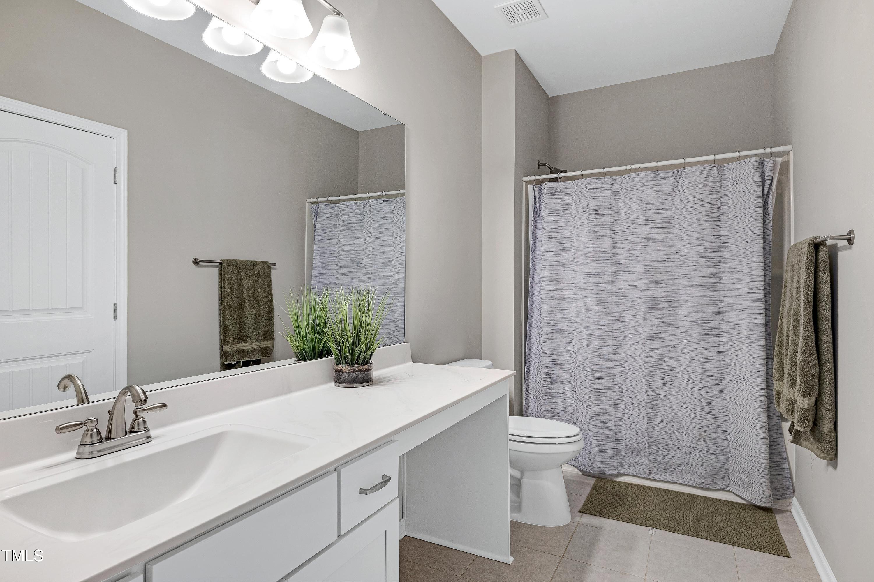 5300 Trilogy Farm Drive Raleigh, NC 27603 - Photo 36 of 50 a bathroom with a sink a toilet and shower