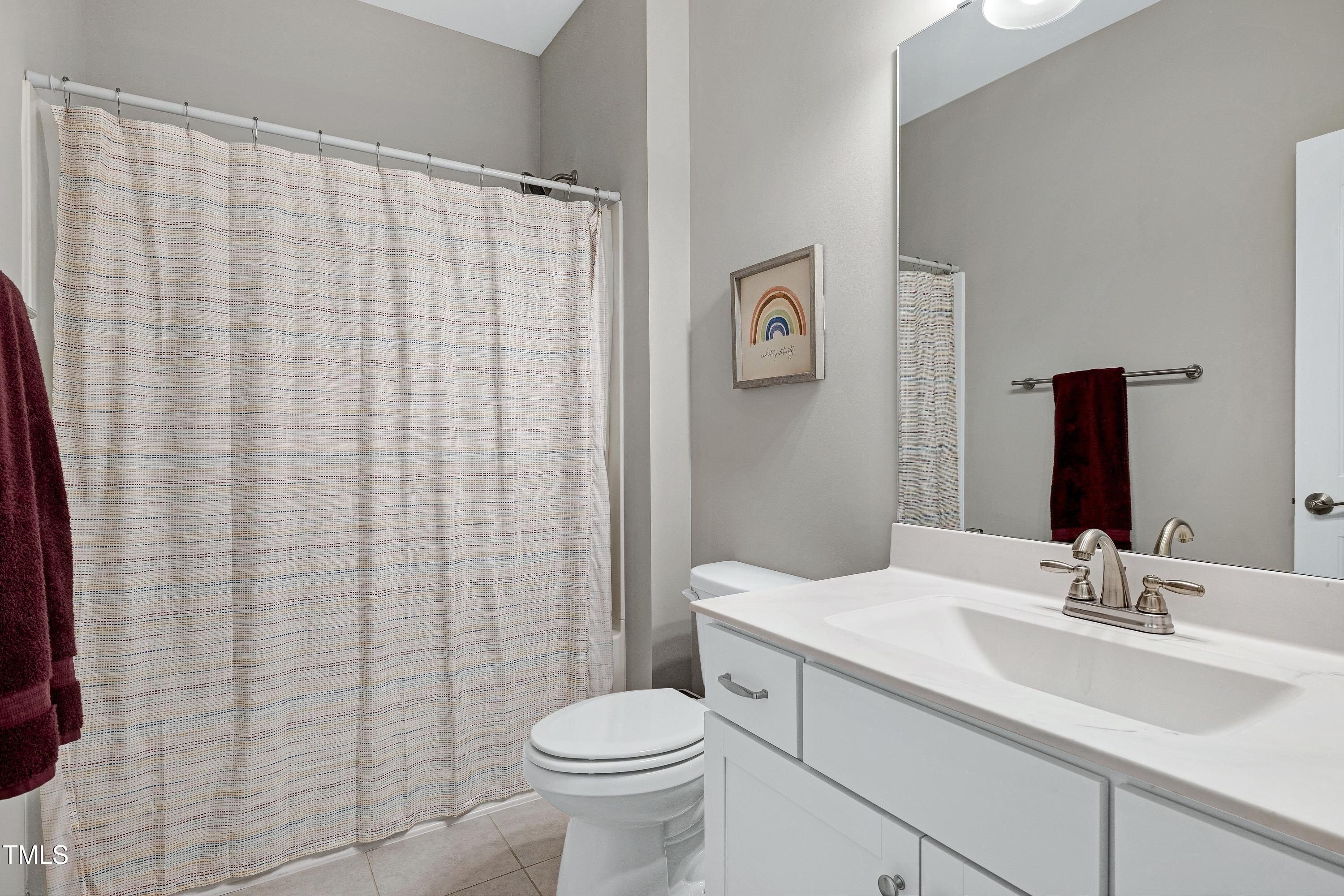 5300 Trilogy Farm Drive Raleigh, NC 27603 - Photo 37 of 50 a bathroom with a sink a toilet and shower curtain