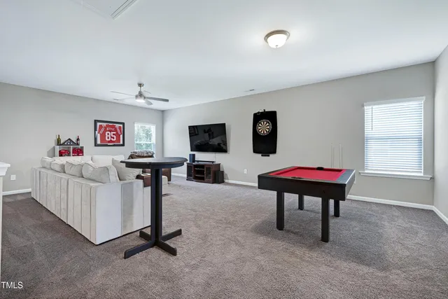 a livingroom with workspace a window and a couch