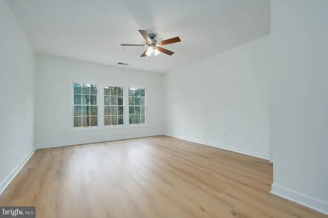 a view of wooden floor and windows in a room
