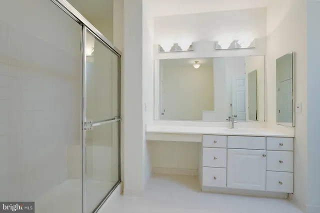 a bathroom with a double vanity sink and mirror