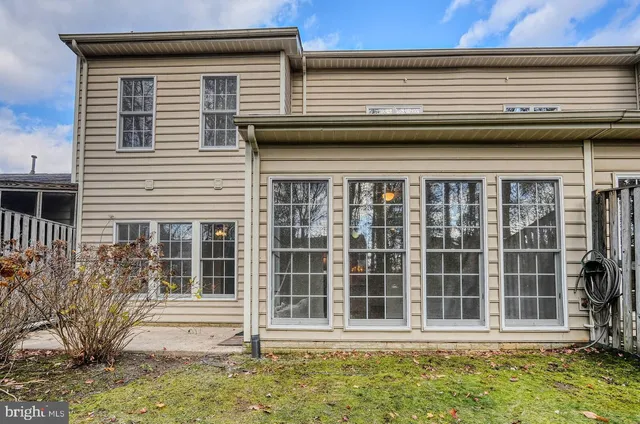 a view of a house with a window and wooden fence