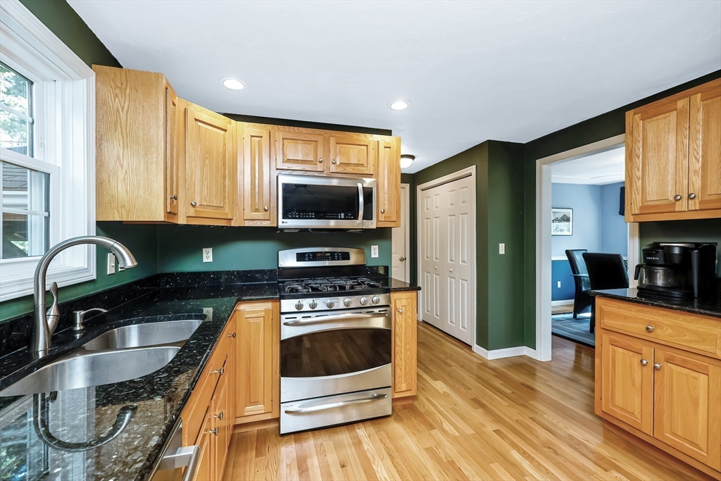 30 Bernardo Drive Attleboro, MA 02703 - Photo 18 of 37 a kitchen with stainless steel appliances granite countertop a stove a sink and a microwave