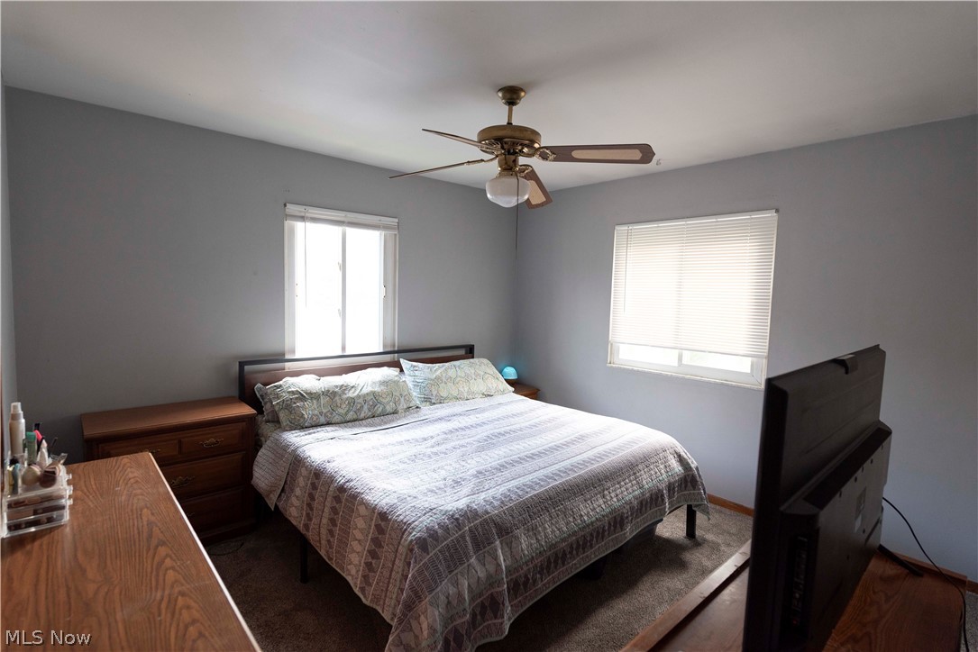 400 Baldwin Road Akron, OH 44312 - Photo 12 of 43 Primary bedroom featuring two windows with blinds, a ceiling fan with integrated lighting, and neutral wall paint