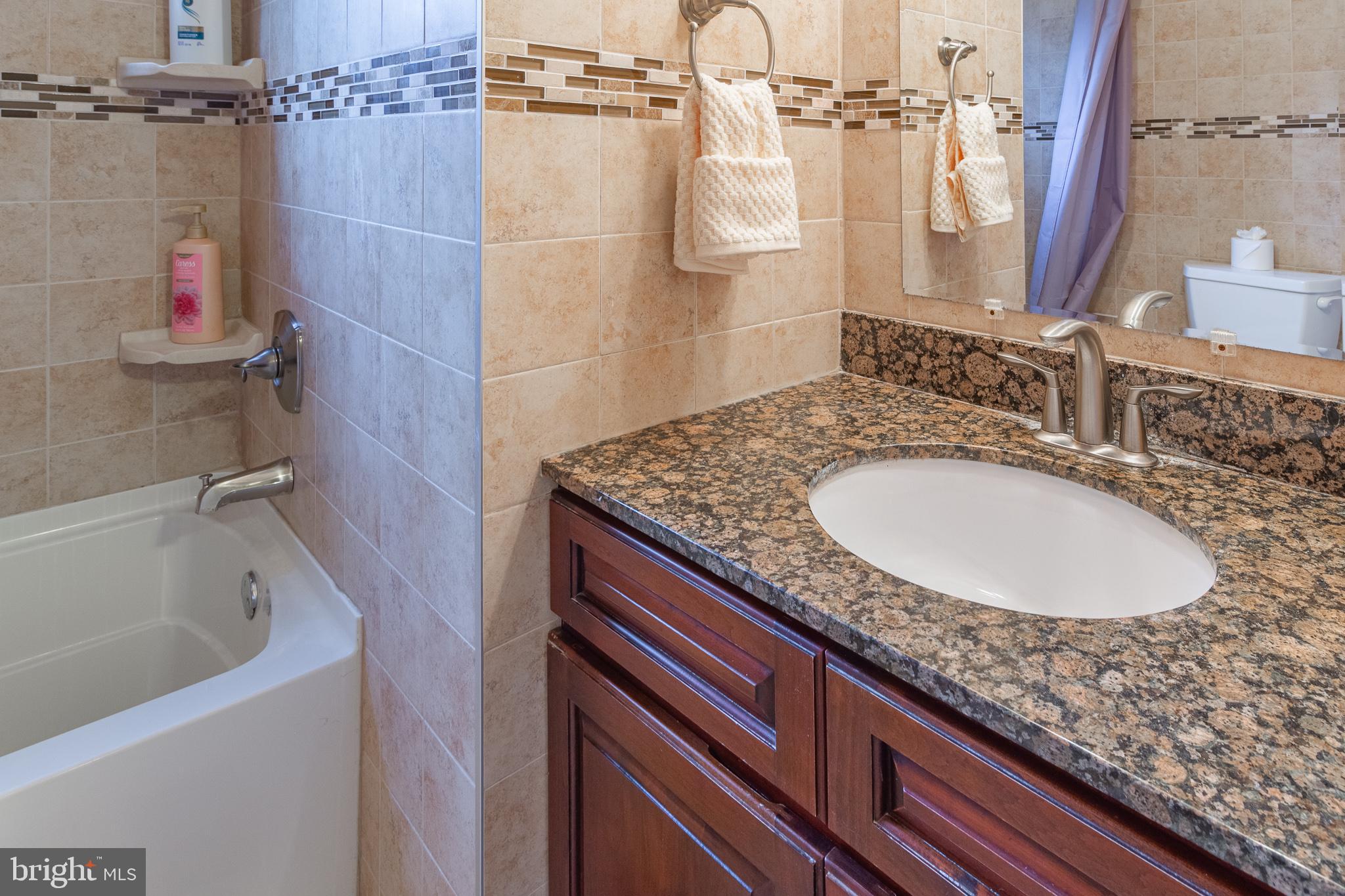 1588 Williams Road Abington, PA 19001 - Photo 27 of 34 a bathroom with a granite countertop sink and a mirror