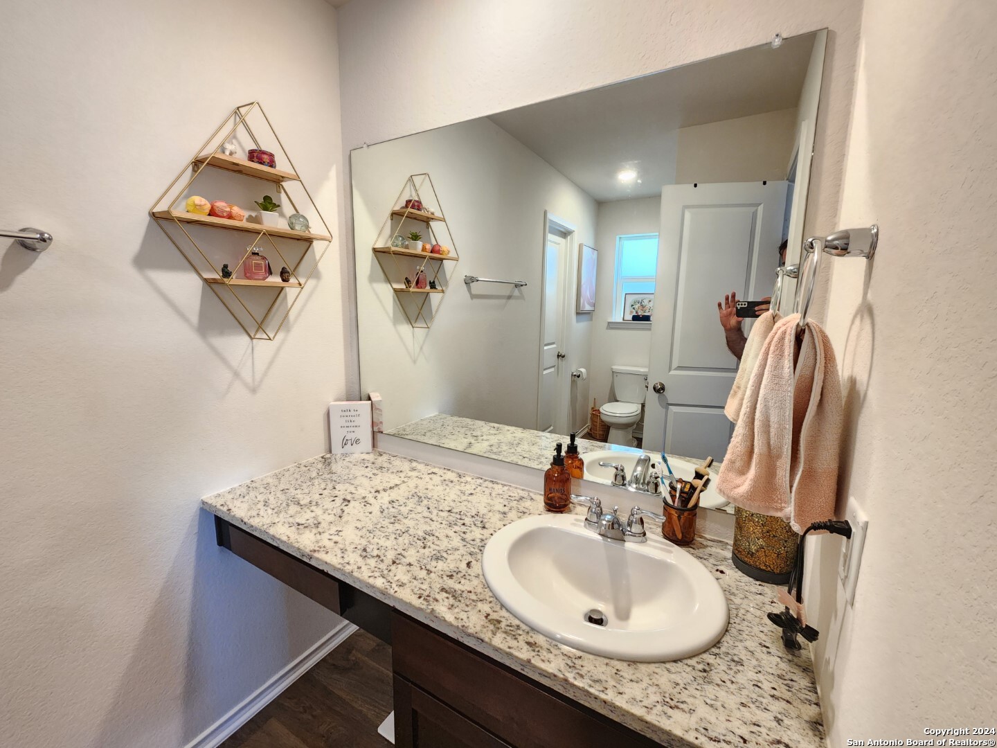 6619 Dynamic Sound San Antonio, TX 78252 - Photo 17 of 20 a bathroom with a granite countertop sink and a mirror