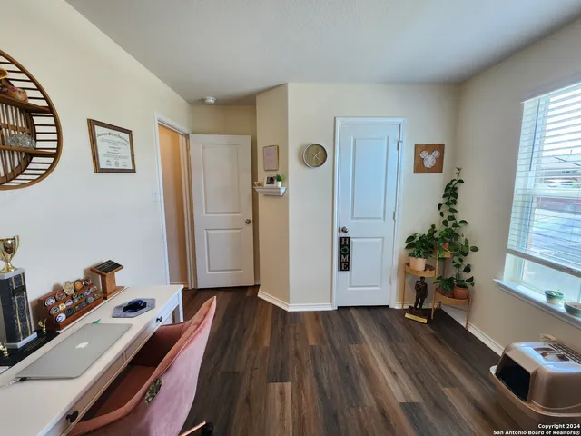 a bedroom with a bed and a computer on it