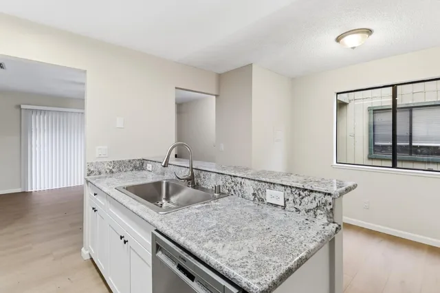 a kitchen with a sink and cabinets