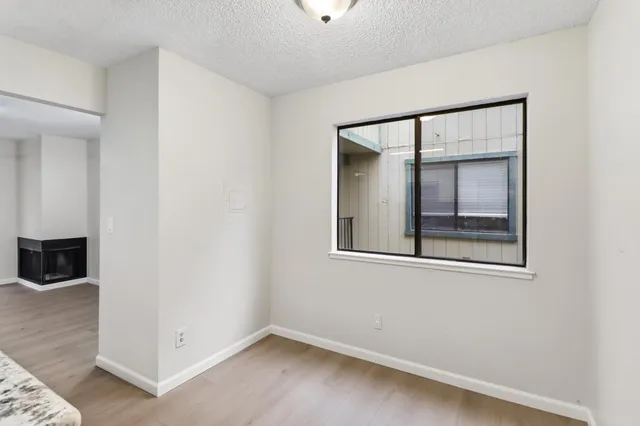 an empty room with a mirror and a window