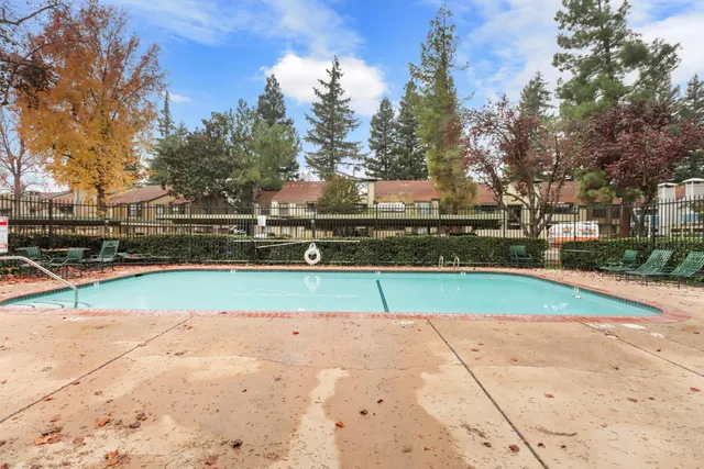 a view of backyard with wooden fence