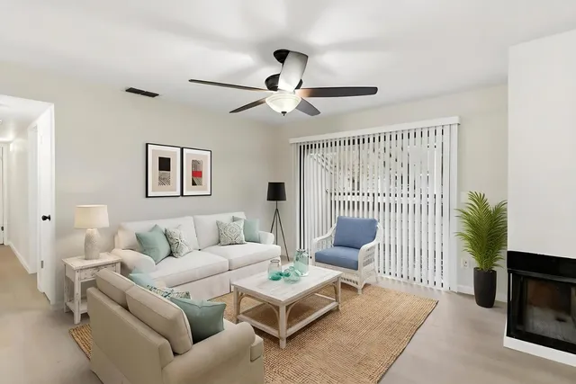 a living room with furniture and a large window