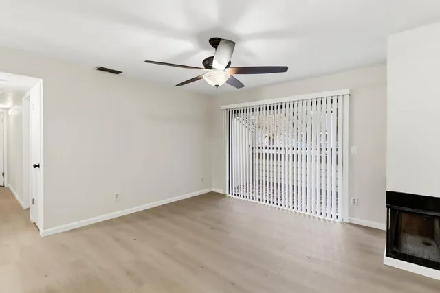 a view of empty room with ceiling fan