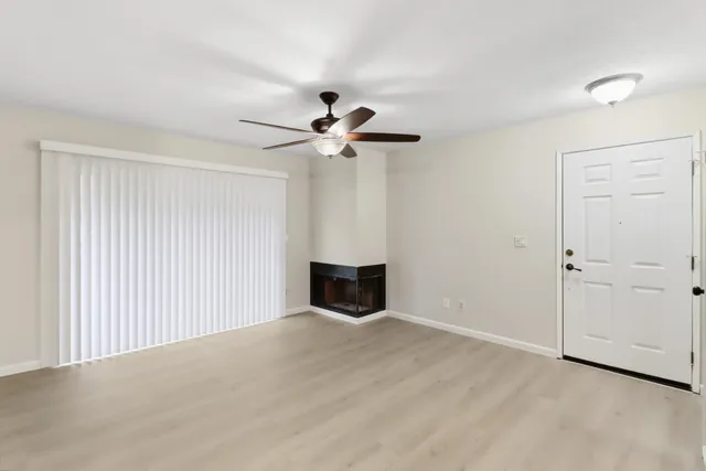 a view of a room with a ceiling fan and a window