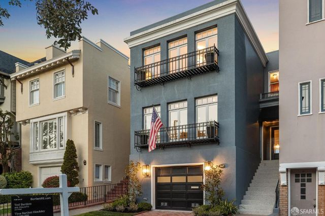 a front view of a house with a yard and mountain view