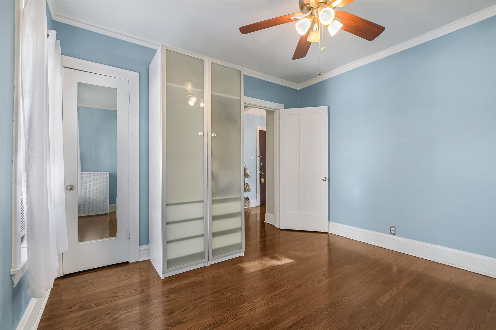 832 Michigan Avenue, Unit 3G Evanston, IL 60202 - Photo 15 of 24 an empty room with wooden floor cabinet and windows