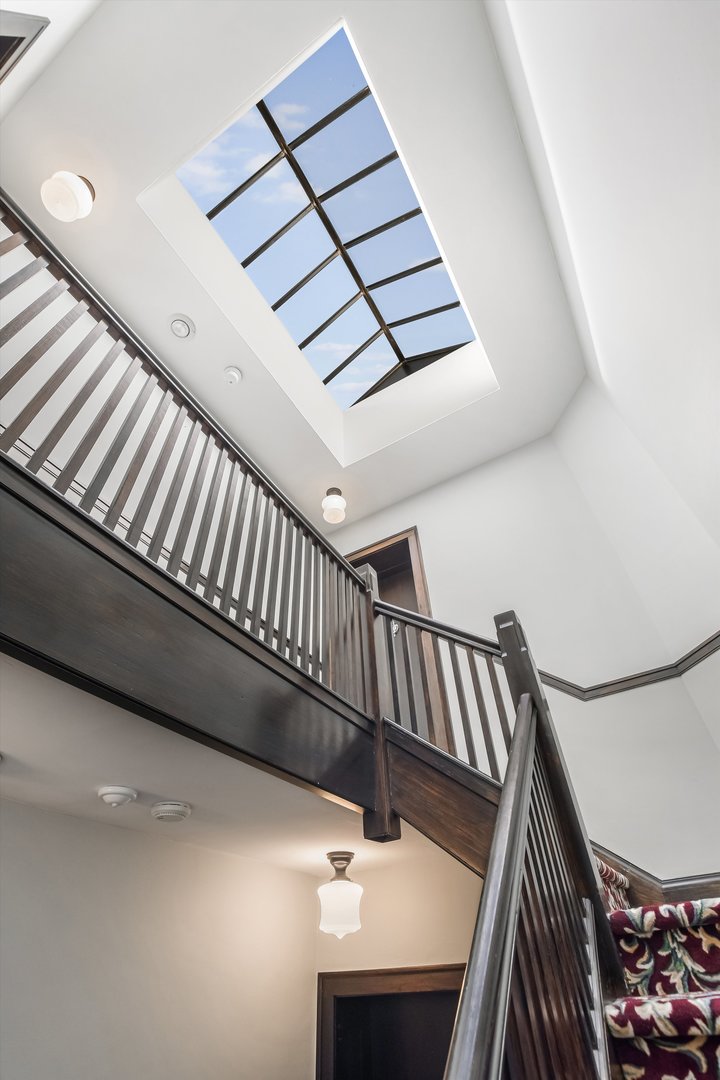 832 Michigan Avenue, Unit 3G Evanston, IL 60202 - Photo 19 of 24 a view of staircase with lots of frames on wall and a window
