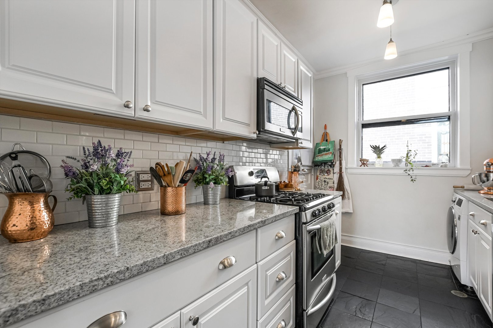 832 Michigan Avenue, Unit 3G Evanston, IL 60202 - Photo 7 of 24 a kitchen with stainless steel appliances granite countertop a sink a stove and cabinets