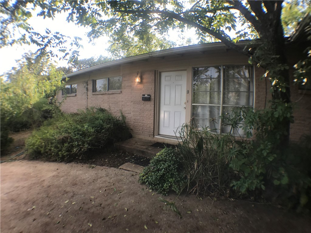 2310 Rebel Road, Unit B Austin, TX 78704 - Photo 2 of 13 a backyard of a house with plants and trees