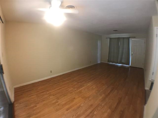 2310 Rebel Road, Unit B Austin, TX 78704 - Photo 5 of 13 an empty room with wooden floor